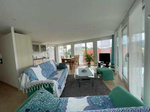 a living room with a couch and a table at Ferienwohnung Hälmli in Heiden
