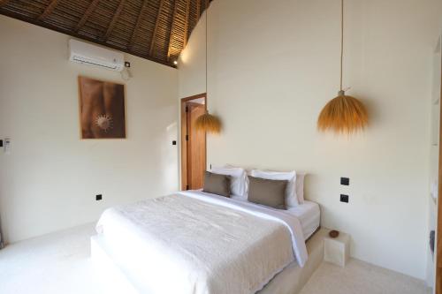 Ένα ή περισσότερα κρεβάτια σε δωμάτιο στο Casa Cabana Solah Villas