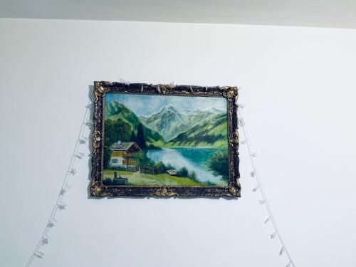 a painting of a lake and a house at Circumvalațiunii Center Apartment in Timişoara