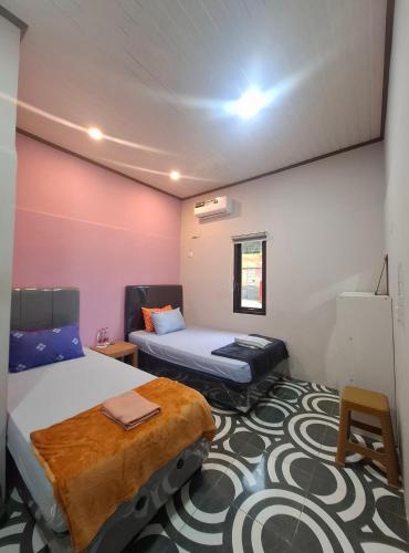 Postel nebo postele na pokoji v ubytování Mangkulio Guest House