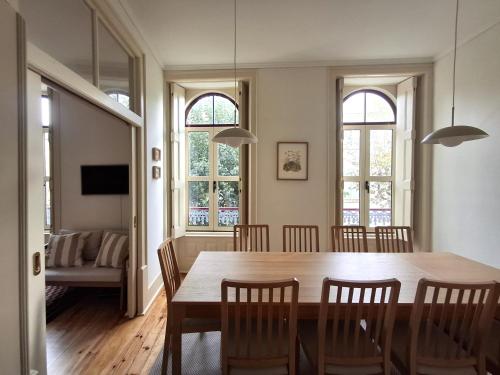 a dining room with a table and chairs at Liberdade 75 Family Holiday House in Figueira da Foz