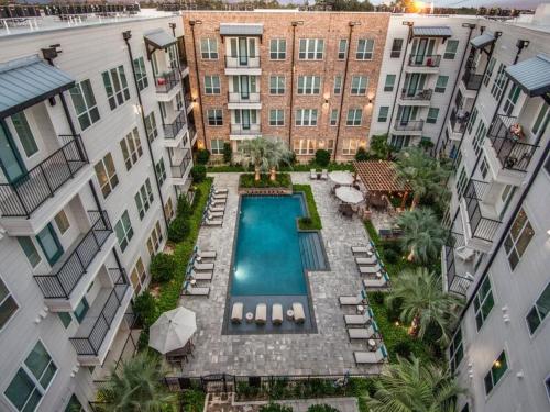 an overhead view of a pool between two buildings at Contemporary Comfort Near The Woodlands in Spring