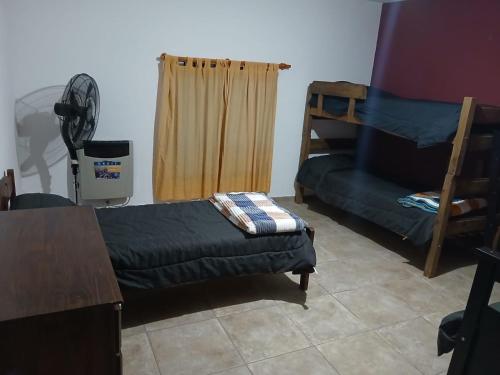 a room with a couch and a bed and a table at Complejo Bru-Mar in Los Olivares