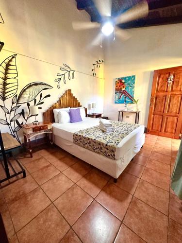 a bedroom with a bed with a mural on the wall at Hotel Al Sole in León
