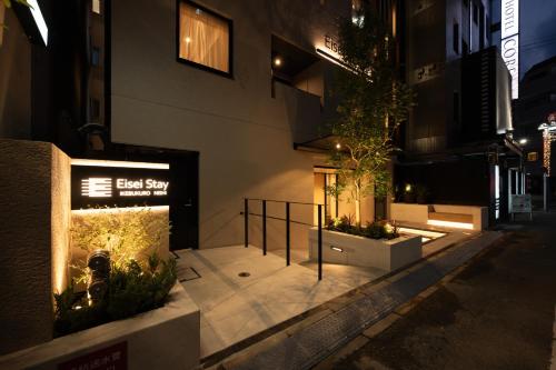a building with a sign that reads best stay at EISEI STAY Ikebukuro Nishi in Tokyo