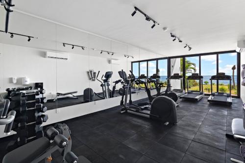 a gym with treadmills and exercise equipment in a building at Oceanfront Luxury 2BR apartment in Puerto Morelos in Puerto Morelos