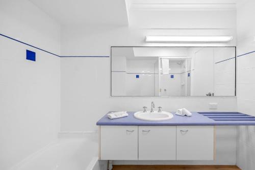 a bathroom with a sink and a mirror at Stay in Seaview Resort, 2 BD apartment with ocean views in Mooloolaba