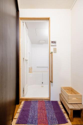 a bathroom with a shower with a glass door at Konoha house【Japanese-style guest house near Asakusa & Skytree】 in Tokyo