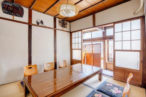 a dining room with a wooden table and chairs at Konoha house【Japanese-style guest house near Asakusa & Skytree】 in Tokyo