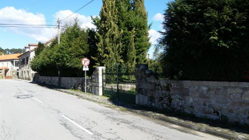 a street with a fence and a no parking sign at Nossa Casa na Aldeia in Viseu