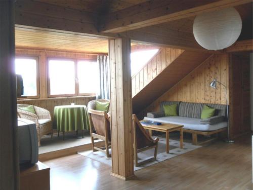 a living room with a couch and a table at Ferienwohnung Nationalparkblick in Spiegelau