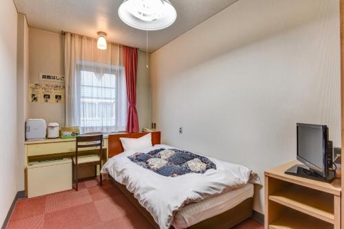 Ένα ή περισσότερα κρεβάτια σε δωμάτιο στο Town Hotel Nakaya