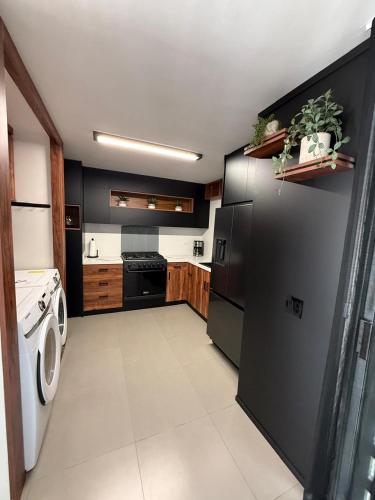 a kitchen with a washer and a washing machine at New House Near The Beach in Ensenada