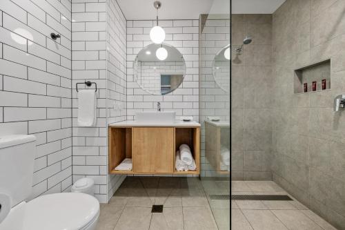 a bathroom with a sink and a toilet and a shower at MJ McMahon Motel in Wonthaggi