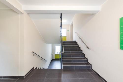 a stairway in a building with a stair case at Candlewood Suites Fürth by IHG in Fürth