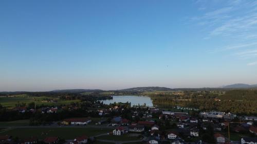 an aerial view of a town and a lake at Morgensonne in Lechbruck