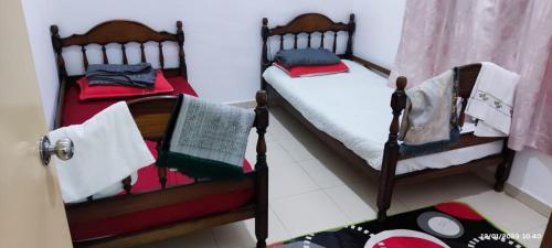 Postel nebo postele na pokoji v ubytování Nana Homestay