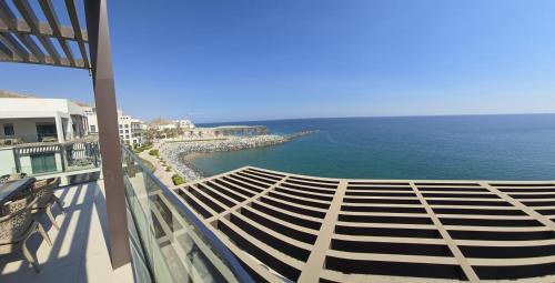 a view of the ocean from the balcony of a building at Solo Realty Apartments at Address Residence Fujairah in Sharm