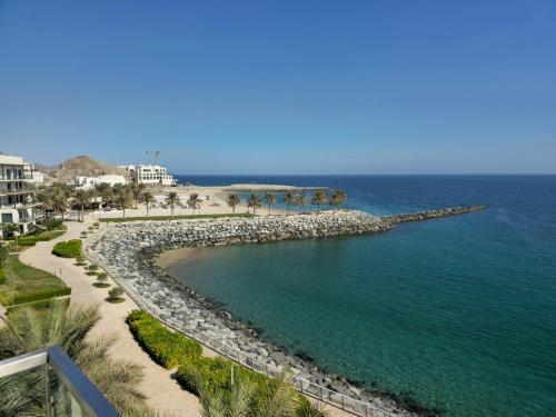 a view of a beach and the ocean at Solo Realty Apartments at Address Residence Fujairah in Sharm