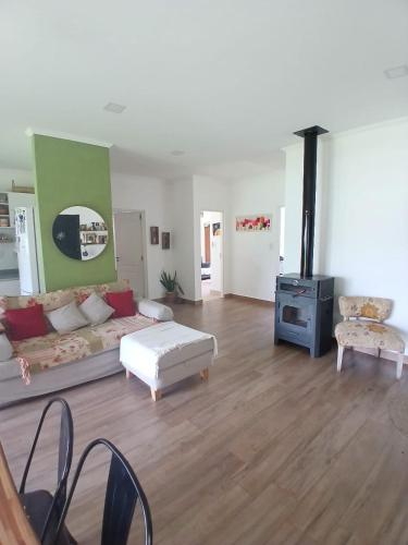 a living room with a couch and a stove at SUKHA in Baradero