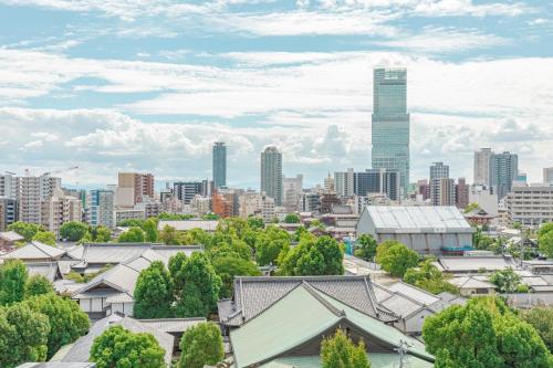 a view of a city with a tall skyscraper at Bureau Sitennoji hotel in Osaka