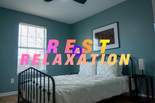 a bedroom with a bed with a sign that reads reset activation at Near Kyle Field - Cottage Close to Campus in College Station