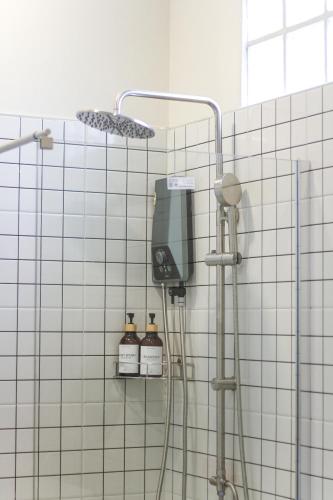 a bathroom with a shower with a soap dispenser at Garden Villa Khaolak in Khao Lak