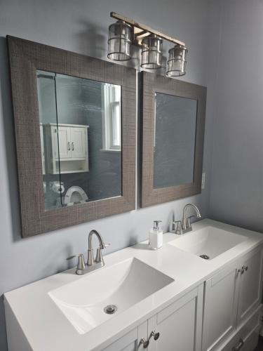 a bathroom with two sinks and a mirror at Cozy Getaway 2-Penn Station,NJPAC,Prudential Center in Kearny