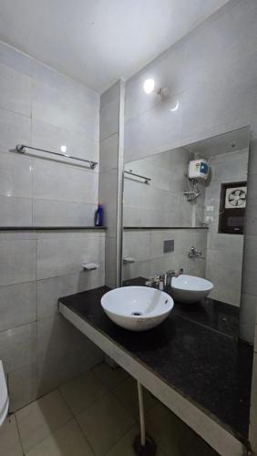 a bathroom with two white sinks on a counter at Shivpuri House Kedarnath in Kedārnāth