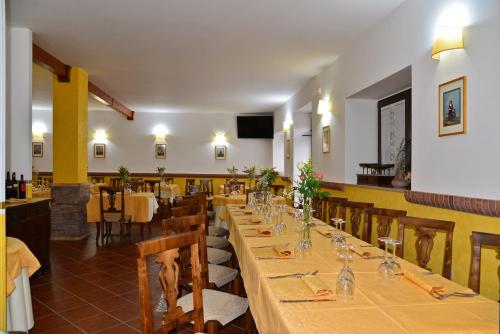 a dining room with a long table and chairs at Bioagriturismo Sant'Elia in Calvello