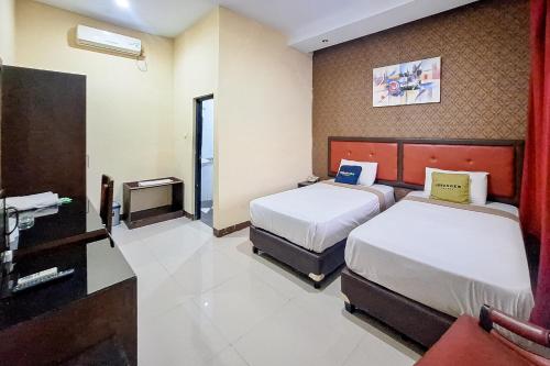 Ένα ή περισσότερα κρεβάτια σε δωμάτιο στο Urbanview Hotel Gumilang Puncak