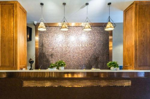 a restaurant with a sign on a brick wall at James Joyce Coffetel Qufu Tourist Center Gulou Street Sankong Scenic Spot in Qufu