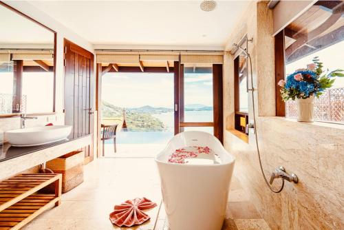 a bathroom with a toilet and a sink and a tub at Sandalwood Luxury Villa Resort in Lamai