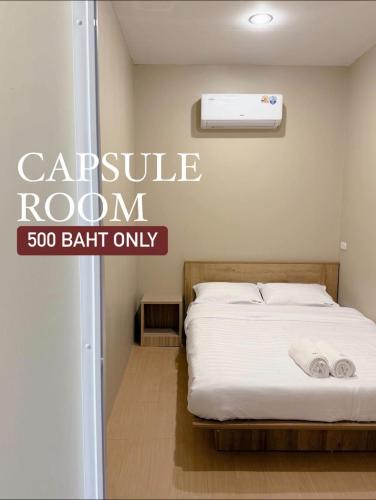 a bed in a room with a sign that reads capsule room bath only at Easy Hotel - 1 min Train Station in Hat Yai