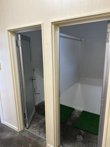 two sliding glass doors in a room with a bathroom at Guest Room Chigasaki in Chigasaki