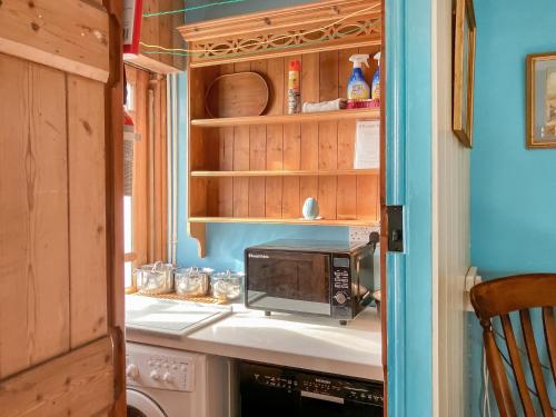 a kitchen with a microwave on a counter at Downhouse in Delabole