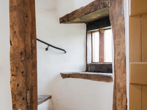 a room with a window and wooden beams at Blaenau - Uk50400 in Llanstephan