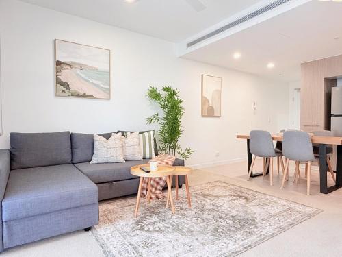 a living room with a couch and a table at Riverside Modern Living 2B2B Apt with Parking in Brisbane