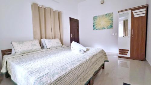 a bedroom with a large bed in a room at Gypsy Walker Plus in Varkala