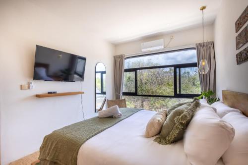 En eller flere senge i et værelse på Thomas Beach Residence