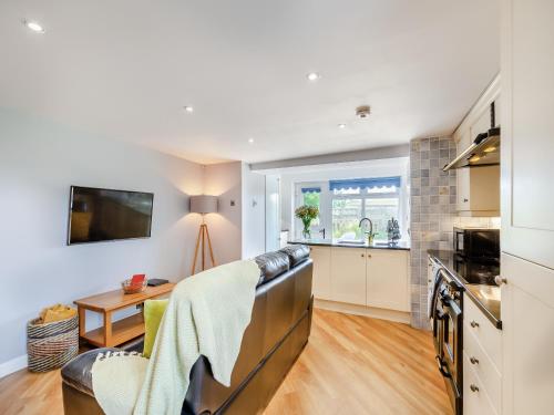 a kitchen and living room with a couch and a table at Beacon - Uk44719 in Ravenscar