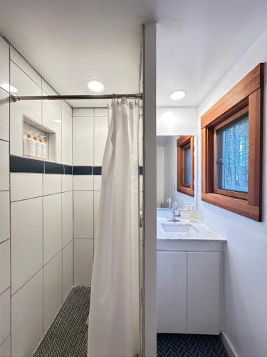 a bathroom with a shower and a sink at Private Pond, Dog-Friendly, Peaceful, Golfing in Eastsound
