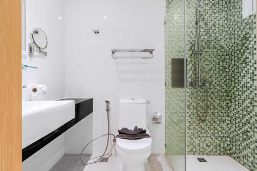 a bathroom with a toilet and a glass shower at C245 Steps from the Beach Pool & Ocean View in Ban Saiyuan (1)