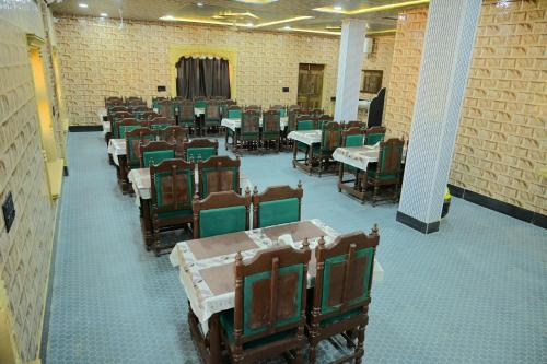 uma fileira de mesas e cadeiras em uma sala em Royal Sand Desert Resort em Sām