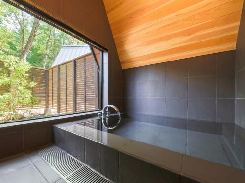 a bathroom with a large window and a bath tub at Villa Yoshino - Vacation STAY 01536v in Azumino