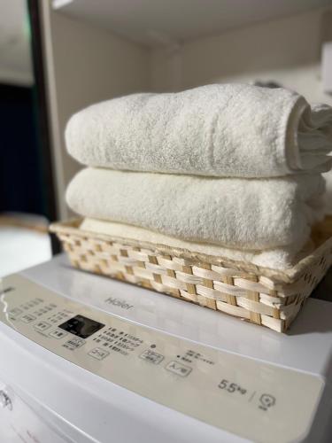 a basket of towels sitting on top of a scale at Shiba inn in Tokyo