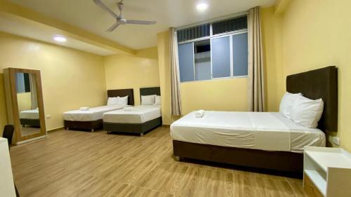 En eller flere senge i et værelse på GRAND HOTEL ViLLA ROSA