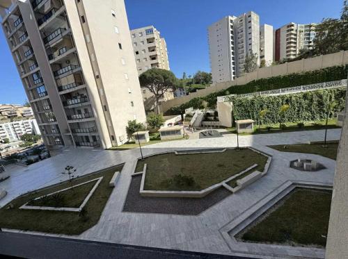 a courtyard in a city with tall buildings at Grand appartement 3 chambres à la résidence valmascort Annaba in Annaba