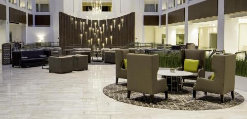 a lobby with chairs and tables and a chandelier at Grand Hyatt Washington in Washington, D.C.