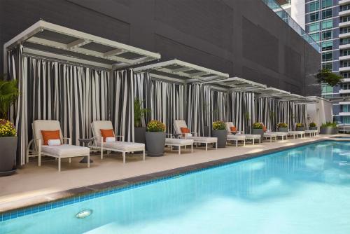 a hotel swimming pool with chairs at Carte Hotel San Diego Downtown, Curio Collection By Hilton in San Diego